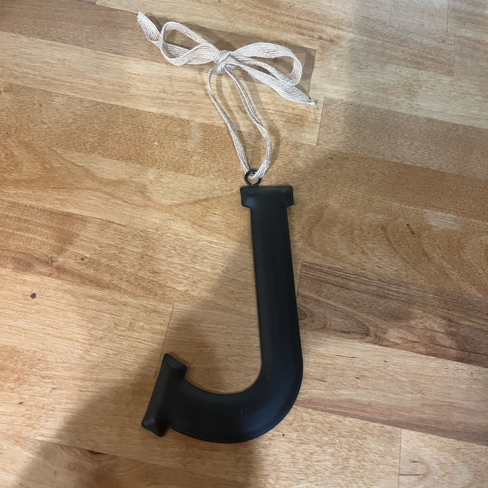 Black metal “J” with burlap tie